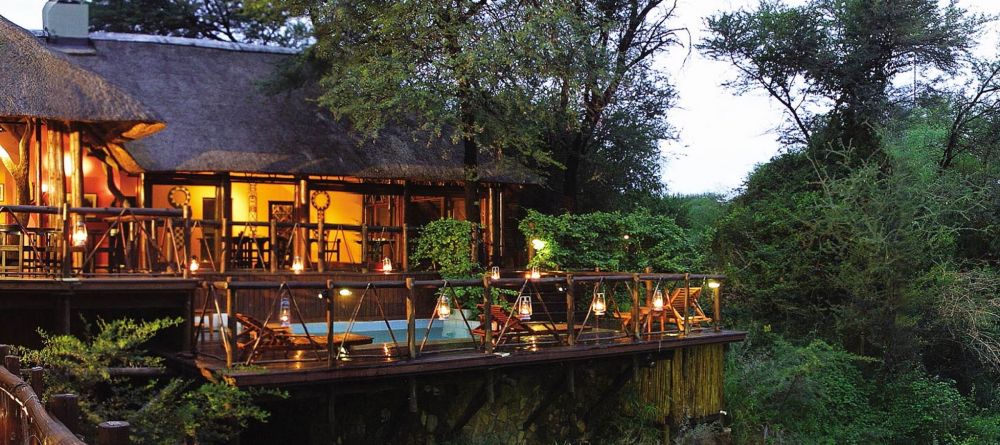 Madikwe River Lodge exterior at dusk - Image 1
