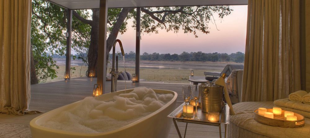 Even the luxurious private soaking tubs have beautiful views over the river at Chinzombo, South Luangwa National Park, Zambia - Image 1