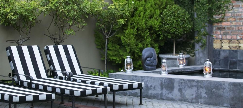 Sun loungers in the courtyard at Welgelegen Boutique Hotel, Cape Town, South Africa - Image 12