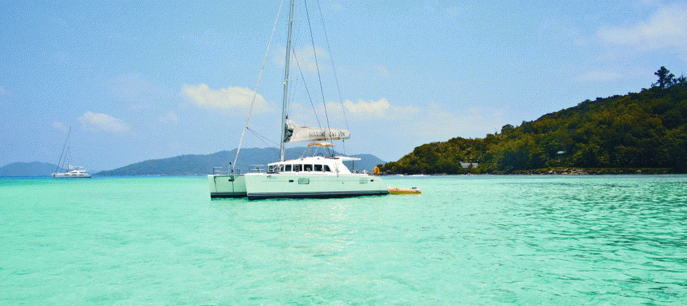 A sailboat just off the beach at New Emerald Cove, Praslin, Seychelles - Image 18