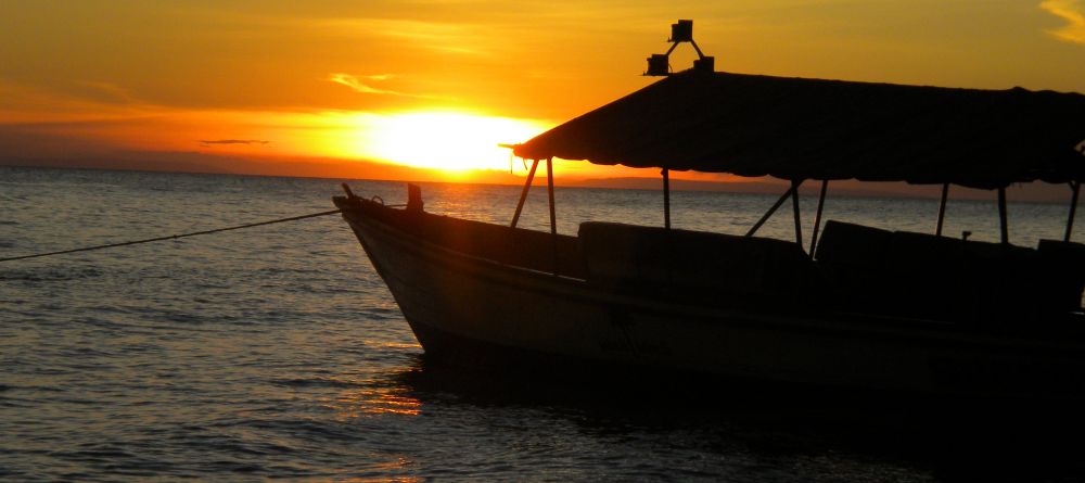 Boat silhouette at sunset at Gombe Forest Lodge, Gombe National Park, Tanzania - Image 14