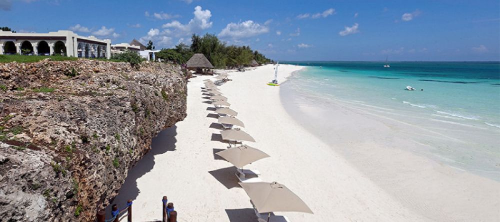 Rows of umbrellas and lounge chairs await guests along the spectacular beach at Hideaway of Nungwi Resort & Spa, Zanzibar, Tanzania - Image 8