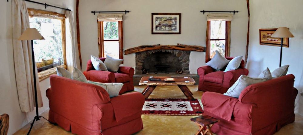 Comfortable chairs and African-inspired decor create a welcoming lounge at Mara House, Masai Mara National Reserve, Kenya - Image 3