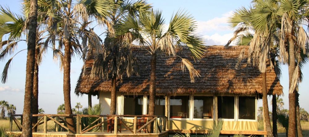 A guest tent shade by a grove of palm trees at Maramboi Tented Camp, Tarangire National Park, Tanzania - Image 4