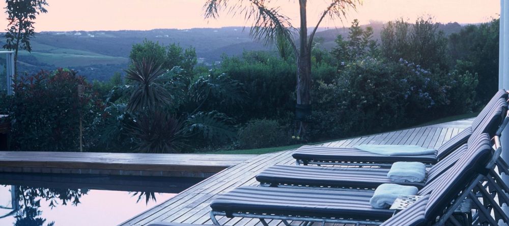 Sun loungers by the pool at sunset at Bosavern Guesthouse, Plettenberg, South Africa - Image 6