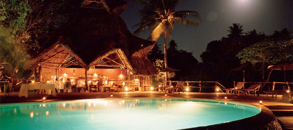 Pool lit up at night at Fundu Lagoon, Pemba Island, Tanzania - Image 6