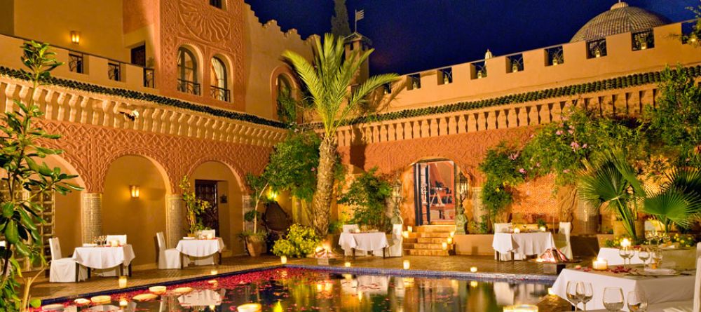 Poolside dining in the evening at Kasbah Tamadot, Atlas Mountains, Morocco - Image 3