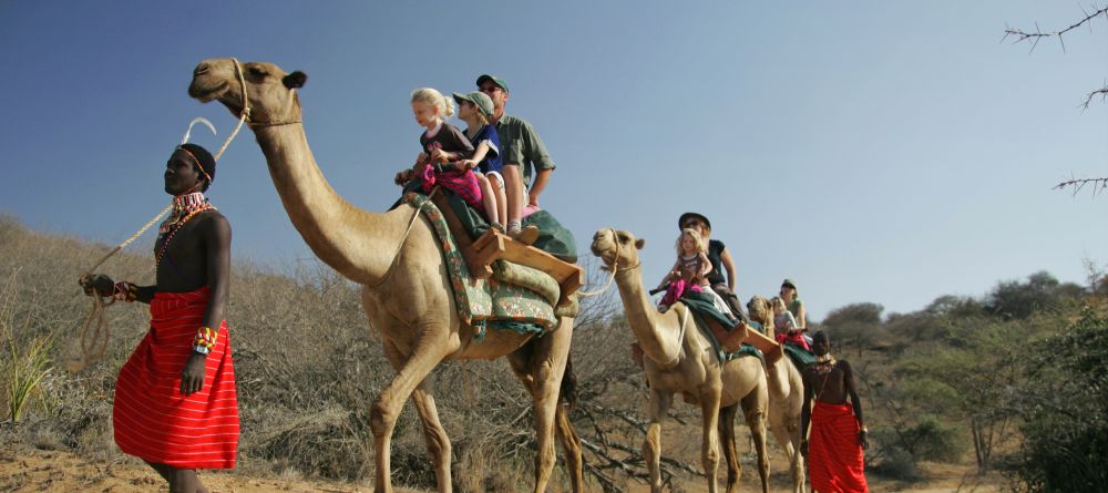 Families enjoying the camel-back safari ride at Sabuk Lodge, Laikipia, Kenya - Image 18
