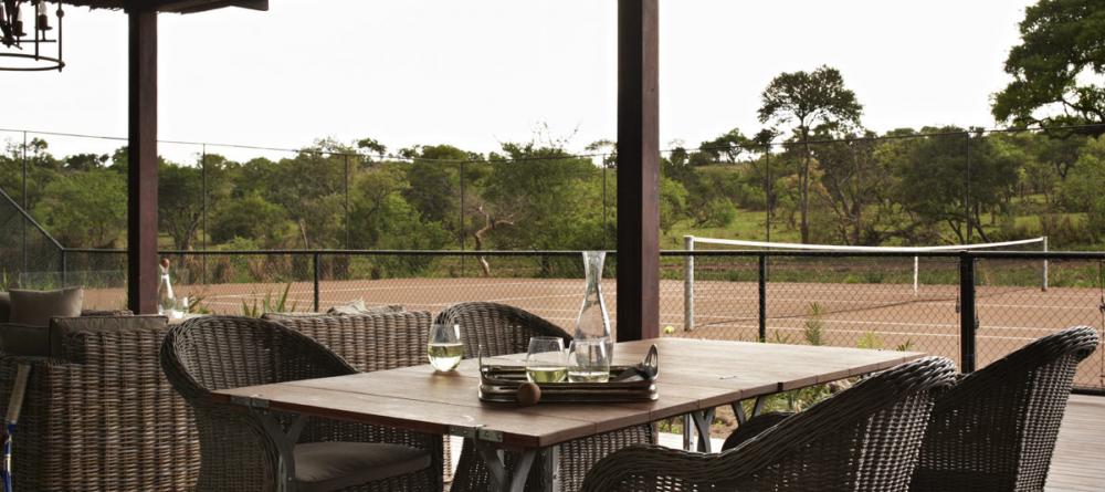 Tennis courts and outdoor dining allows guests to enjoy nature from the comfort of Singita Serengeti House, Serengeti Grumeti Reserves, Tanzania - Image 2