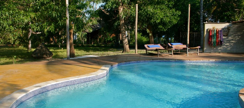 Soak up sun by the pool at Pole Pole Bungalow Resort, Mafia Island, Tanzania - Image 11