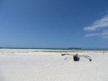 A lone wooden boat sits on the beach, awaiting a guest to explore the crystal turquoise waters at The Residence Zanzibar, Zanzibar, Tanzania (Mango staff photo)