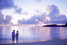 Romantic sunset walk on the beach at Raffles Praslin, Praslin, Seychelles
