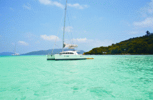 A sailboat just off the beach at New Emerald Cove, Praslin, Seychelles