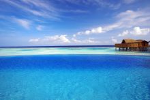 The infinity pool blends seemlessly into the ocean vistas to create a breath-taking and unforgettable experience for guests at Kuredu Island Resort, Lhaviyani Atoll, Maldives
