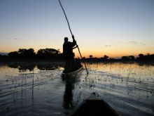 Boating at sunset at Guma Lagoon Camp, Okavango Delta, Botswana