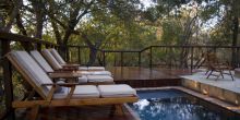 The pool deck with sunloungers at Shumbalala Game Lodge, Thornybush Game Reserve, South Africa