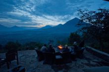 Campfire overlooking mountains and valley at Virunga Lodge, Volcanoes National Park, Uganda