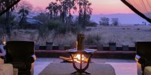 Take in the sounds of Africa at sunset while lounging by the campfire at Chem Chem Lodge, Lake Manyara National Park, Tanzania