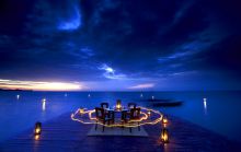 Dining on the jetty at night at Rusinga Island Lodge, Lake Victoria, Kenya