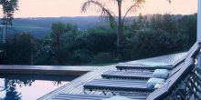 Sun loungers by the pool at sunset at Bosavern Guesthouse, Plettenberg, South Africa