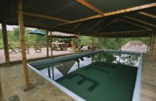 Pool with dining area behind at Sable Mountain Lodge, Selous National Park, Tanzania