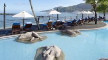 Sun loungers and and ocean view from the pool at Le Meridien Fishermans Cove, Mahe, Seychelles