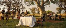 Savor dining at sunset while watching a traditional dance performance at Singita Sasakwa Lodge, Grumeti Reserves, Tanzania