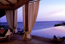 Watch the sunset from a private veranda at Alfajiri Villas, Diani Beach, Tanzania