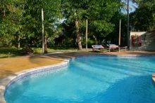 Soak up sun by the pool at Pole Pole Bungalow Resort, Mafia Island, Tanzania